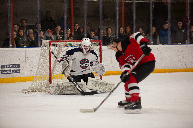 The unedited image of a hockey player on a breakaway - Tips for Editing Hockey Photos in Lightroom